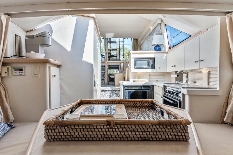 Slide: The Image of Interior of 2000 Carver 326 Aft Cabin Motor Yacht, featuring modern kitchen amenities. - 7
