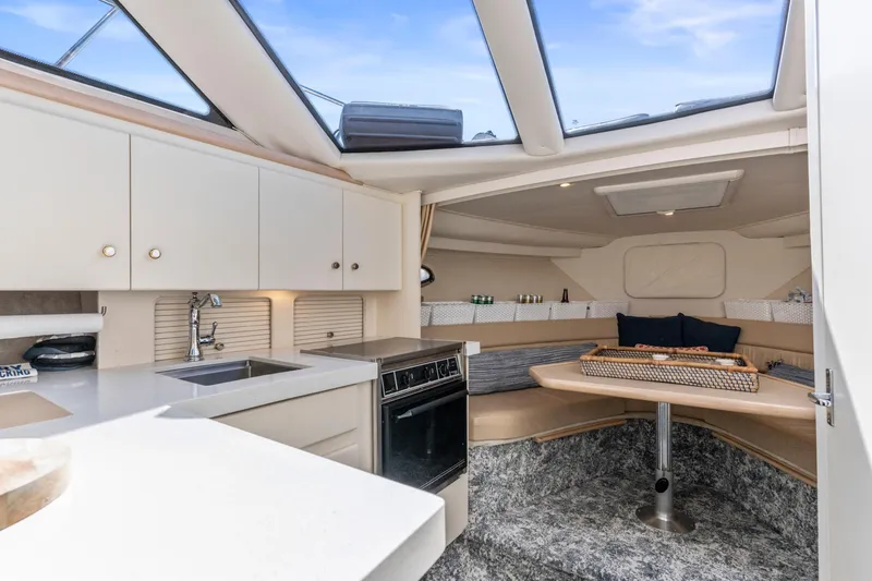 Slide: The Image of Interior of 2000 Carver 326 Aft Cabin Motor Yacht with kitchen and seating area. - 9