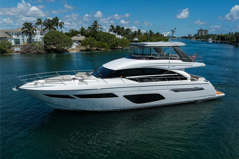 Slide: The Image of Luxurious 2020 Princess F70 yacht cruising on a sunny day, surrounded by scenic waterfront homes. - 10