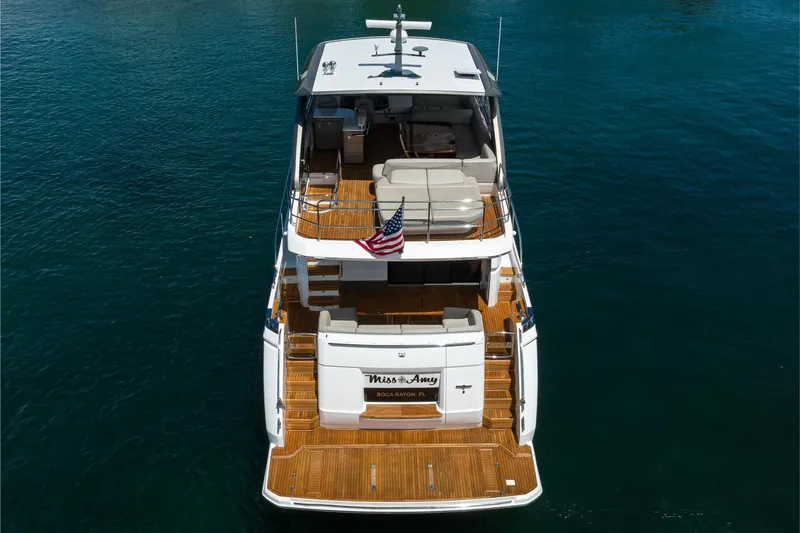 Slide: The Image of Aerial view of 2020 Princess F70 yacht on water, featuring spacious deck and American flag. - 13