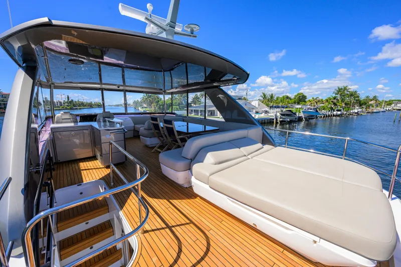 Slide: The Image of Luxurious 2020 Princess F70 yacht deck with seating, overlooking serene waterfront. - 58