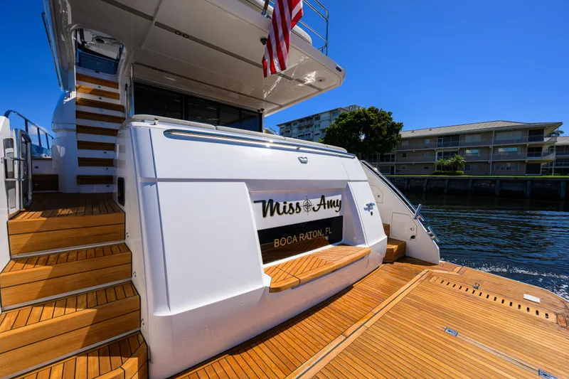 Slide: The Image of Luxury Princess F70 yacht "Miss Amy" docked, featuring elegant wooden deck and stairs, 2020 model. - 65