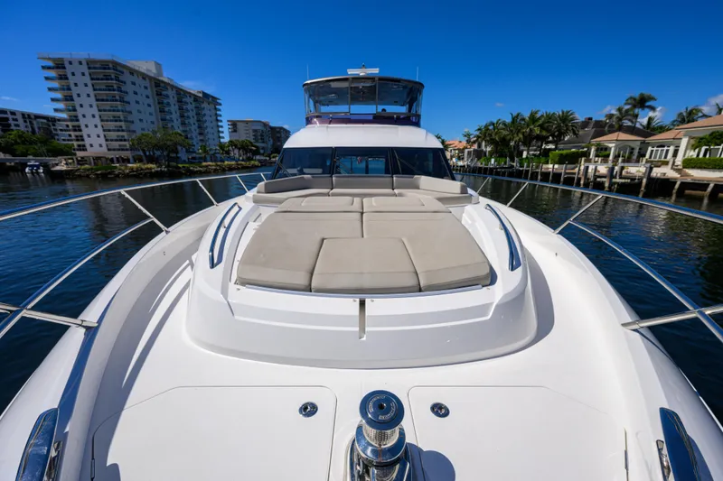 Slide: The Image of 2020 Princess F70 yacht with sun deck, docked near waterfront homes. - 69