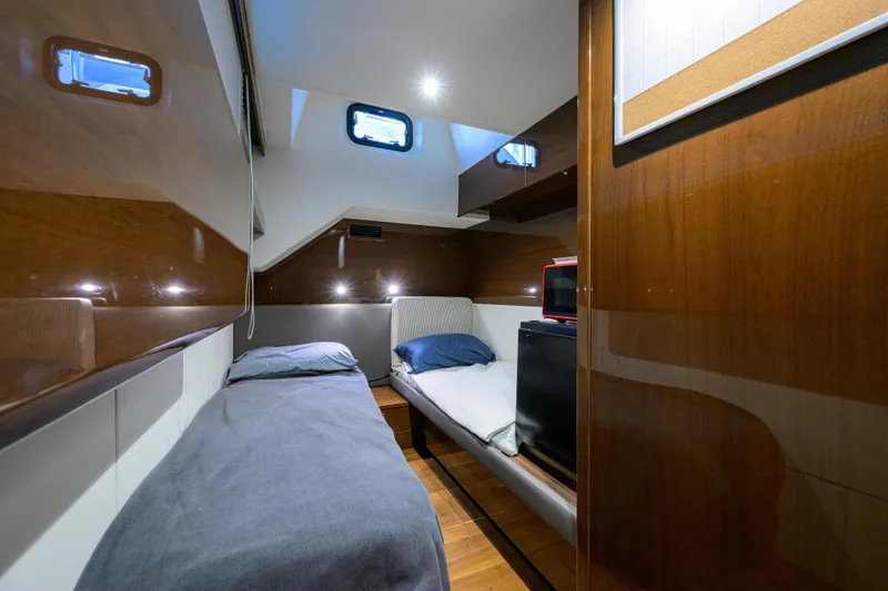 Slide: The Image of Luxurious cabin interior of 2020 Princess F70 yacht with twin beds and wooden finish. - 71