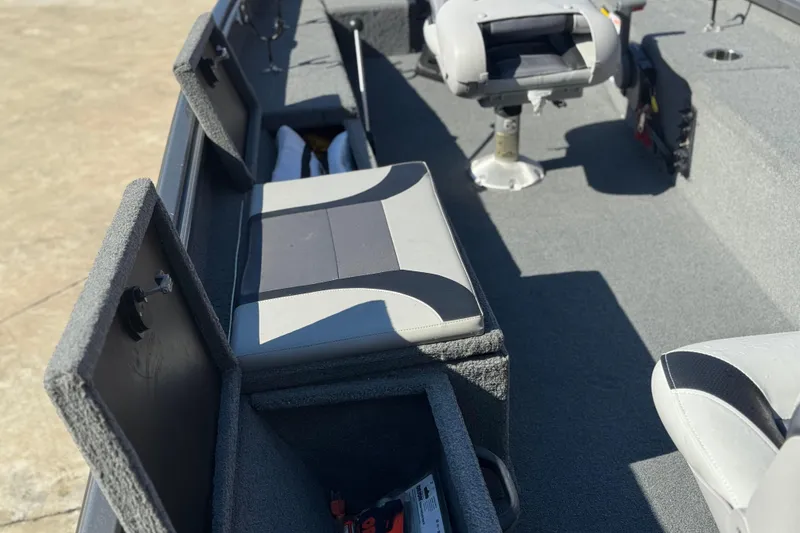 Slide: The Image of 2018 Alumacraft Crappie Deluxe boat interior with storage compartments and seating. - 10