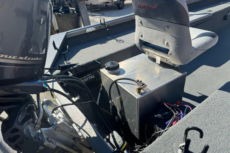 Slide: The Image of 2018 Alumacraft Crappie Deluxe boat interior with motor and seating. - 14