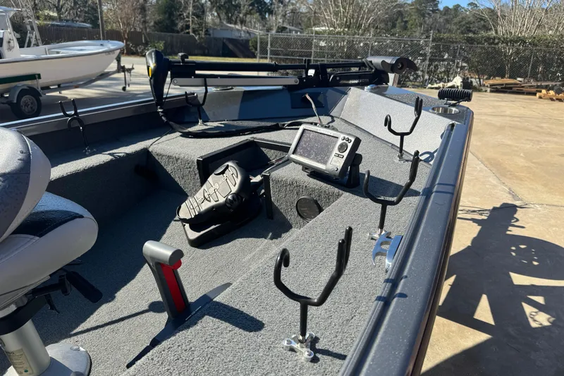 Slide: The Image of 2018 Alumacraft Crappie Deluxe boat interior with fishing rod holders and electronic equipment. - 15