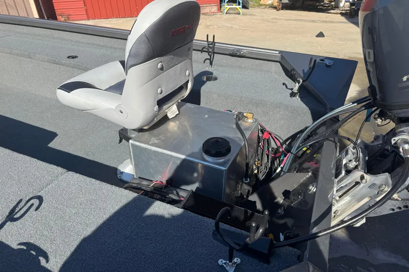 Slide: The Image of 2018 Alumacraft Crappie Deluxe boat interior with seat and engine components. - 6