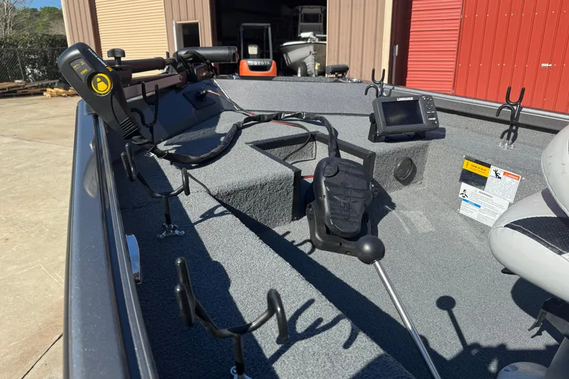 Slide: The Image of 2018 Alumacraft Crappie Deluxe boat interior with fishing equipment and navigation system. - 8