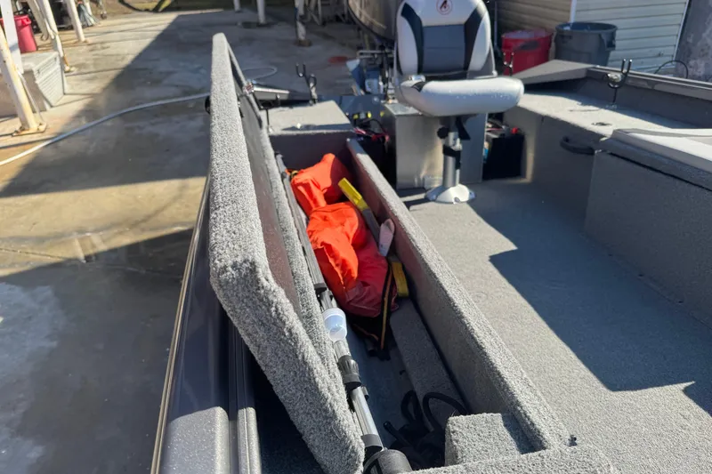 Slide: The Image of 2018 Alumacraft Crappie Deluxe boat interior with storage compartment and seating. - 9