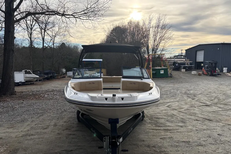 Slide: The Image of 2023 Sea Ray SPX 210 boat on trailer in outdoor storage area. - 11