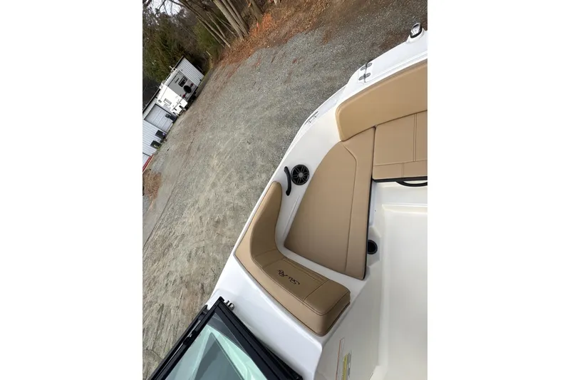 Slide: The Image of 2023 Sea Ray SPX 210 boat interior with tan seating and speaker. - 14