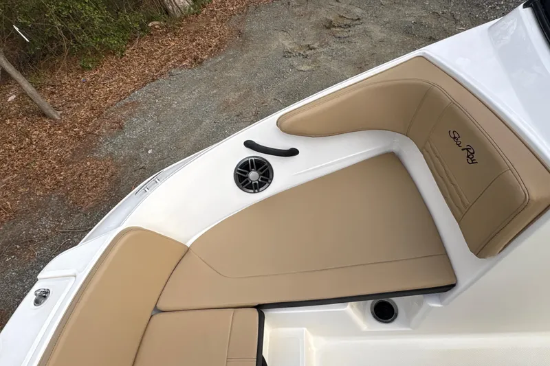 Slide: The Image of 2023 Sea Ray SPX 210 boat interior with tan seating and speaker detail. - 15