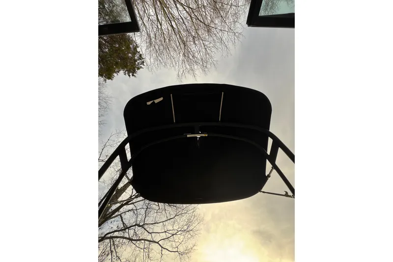 Slide: The Image of 2023 Sea Ray SPX 210 boat canopy viewed from below against a cloudy sky. - 18