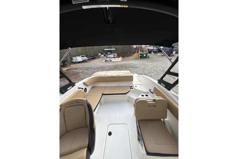 Slide: The Image of 2023 Sea Ray SPX 210 boat interior with tan seating and open deck layout. - 19