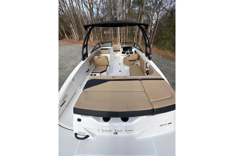 Slide: The Image of 2023 Sea Ray SPX 210 boat interior with tan seating and sleek design. - 2