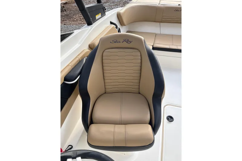 Slide: The Image of 2023 Sea Ray SPX 210 boat seat, tan and black upholstery, luxurious design. - 20