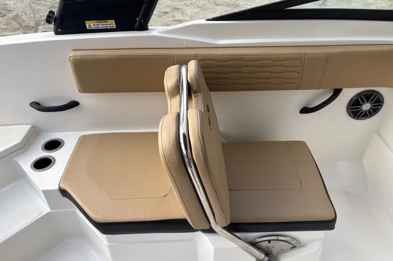 Slide: The Image of 2023 Sea Ray SPX 210 boat interior with tan seating and cup holders. - 22