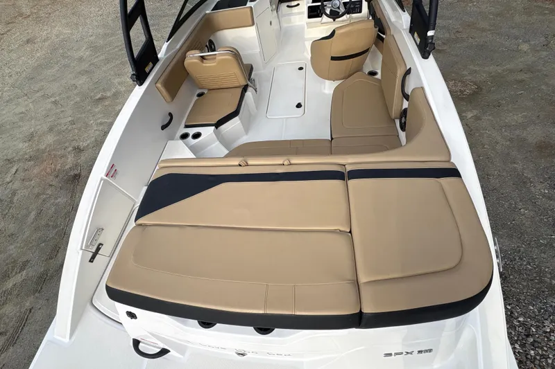 Slide: The Image of 2023 Sea Ray SPX 210 boat interior with tan seating and modern design. - 24