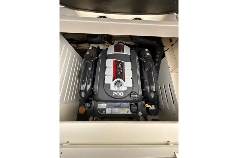 Slide: The Image of 2023 Sea Ray SPX 210 engine compartment showcasing powerful 4.5L 200 HP engine. - 25
