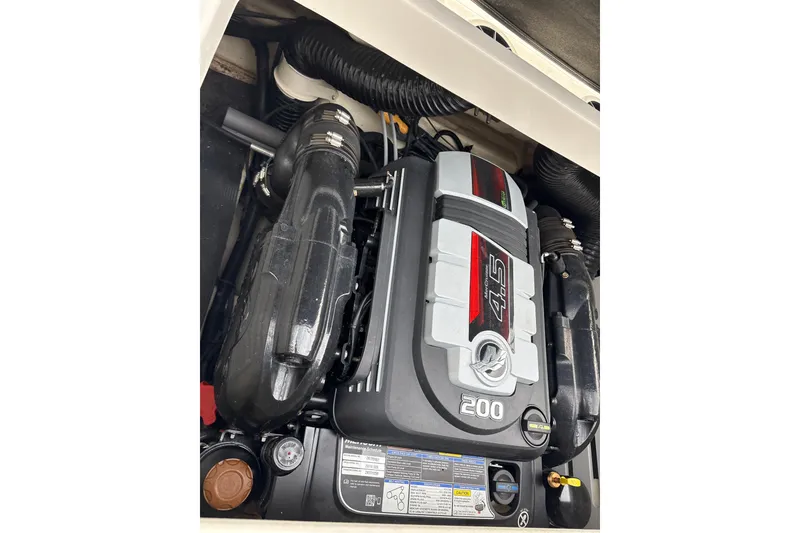 Slide: The Image of 2023 Sea Ray SPX 210 engine compartment showcasing powerful 4.5L engine. - 26