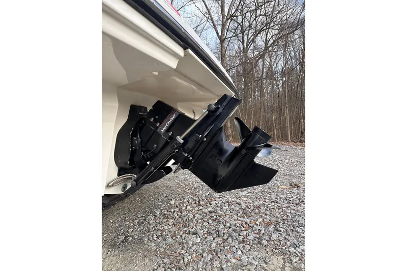 Slide: The Image of 2023 Sea Ray SPX 210 boat with MerCruiser engine, parked on gravel near trees. - 28