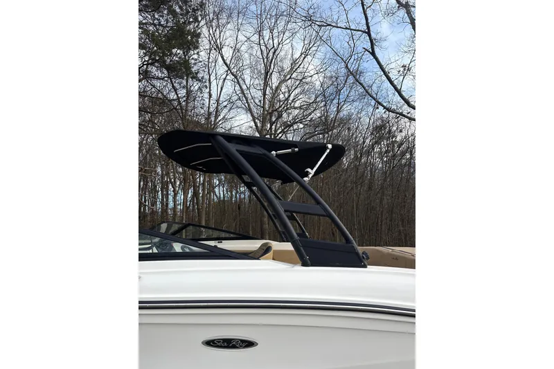 Slide: The Image of 2023 Sea Ray SPX 210 boat with sleek black tower against a wooded backdrop. - 4