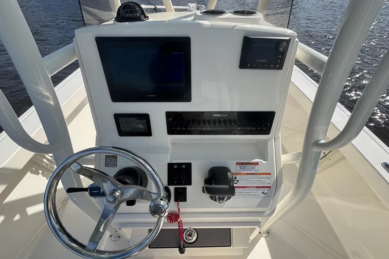 Slide: The Image of 2023 Pathfinder 2400 TRS boat console with steering wheel and navigation controls. - 6