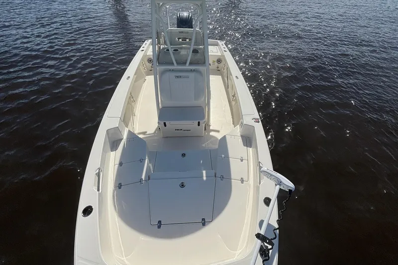 Slide: The Image of 2023 Pathfinder 2400 TRS boat on water, showcasing spacious deck and seating. - 7