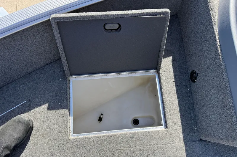 Slide: The Image of Open storage compartment in 2014 Lund 1875 Impact SS boat, showing interior details. - 11