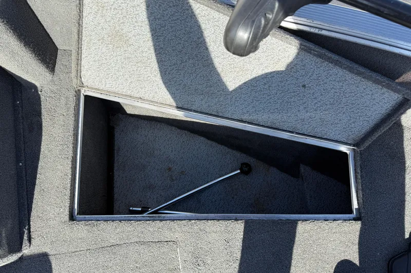 Slide: The Image of 2014 Lund 1875 Impact SS boat storage compartment with metal rod inside. - 12