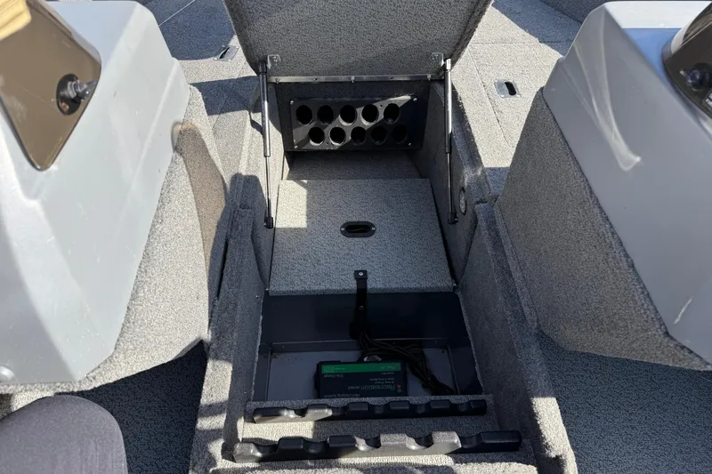 Slide: The Image of 2014 Lund 1875 Impact SS boat interior storage compartment with rod holders. - 14