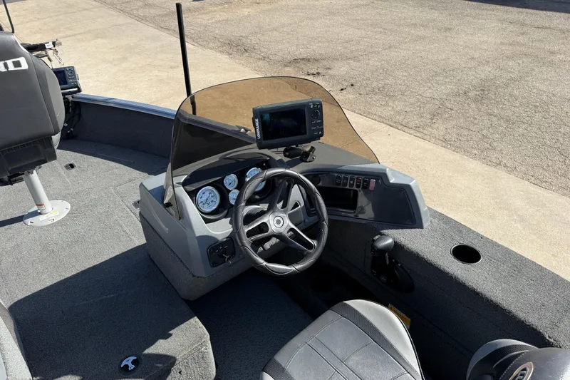 Slide: The Image of 2014 Lund 1875 Impact SS boat cockpit with steering wheel and control panel. - 17