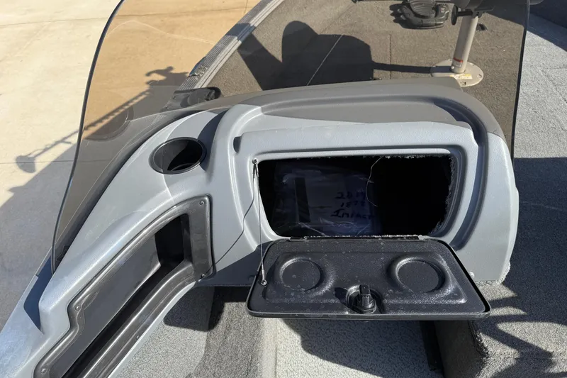 Slide: The Image of 2014 Lund 1875 Impact SS boat dashboard with open storage compartment. - 21