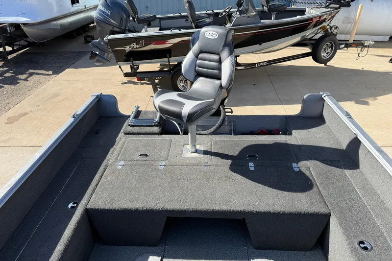 Slide: The Image of 2014 Lund 1875 Impact SS boat interior with swivel seat and storage compartments. - 23