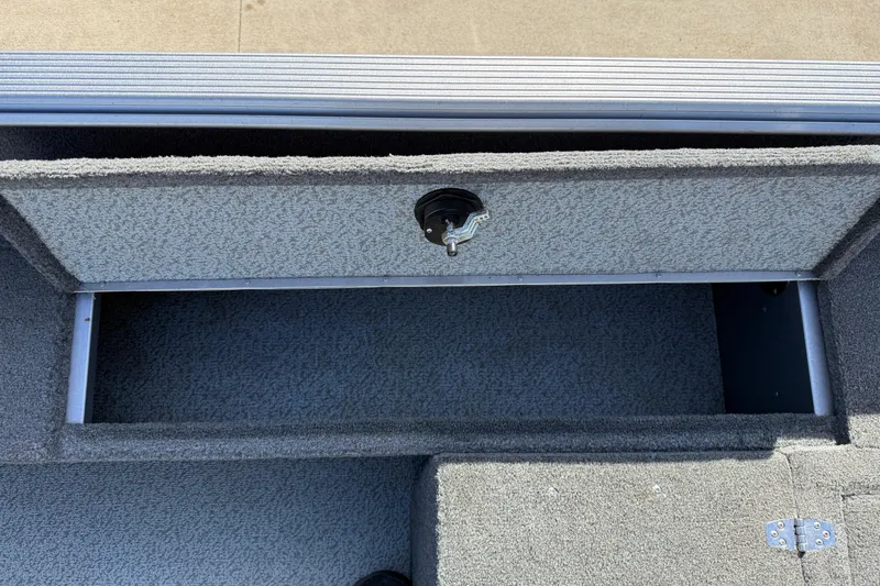 Slide: The Image of 2014 Lund 1875 Impact SS boat storage compartment with key lock. - 24