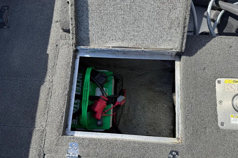 Slide: The Image of Open battery compartment in 2014 Lund 1875 Impact SS boat, showing Interstate battery. - 27