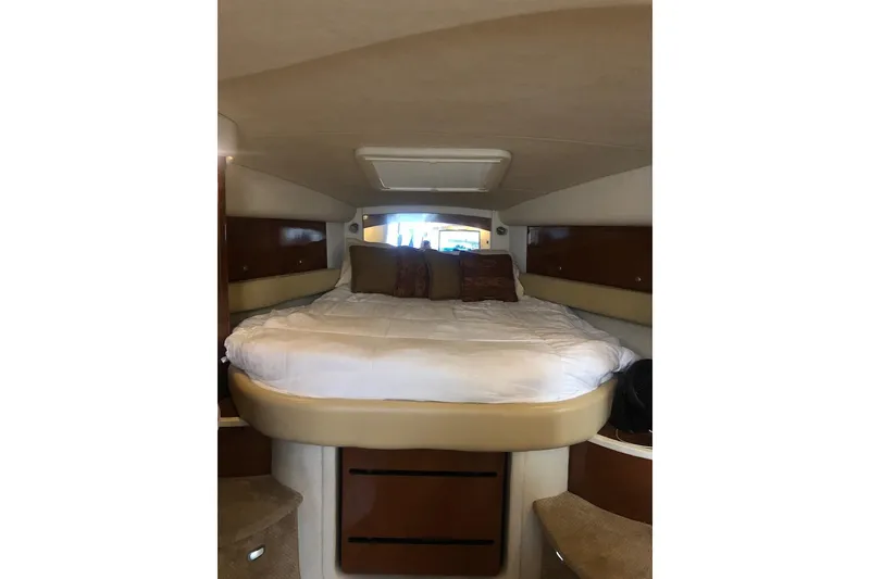 Slide: The Image of 2008 Sea Ray 340 Sundancer cabin with cozy bed and wooden accents. - 16
