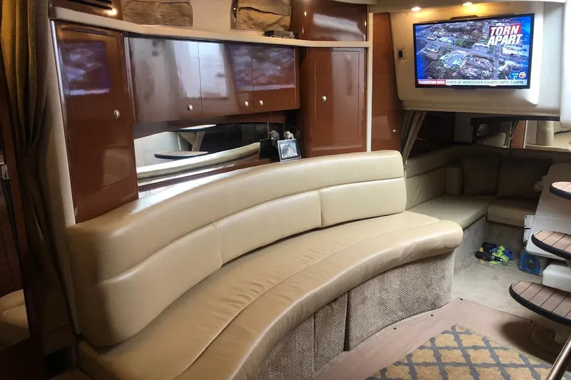 Slide: The Image of Interior of 2008 Sea Ray 340 Sundancer yacht with curved seating and mounted TV. - 18