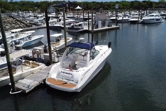 Slide: The Image of 2008 Sea Ray 340 Sundancer yacht docked at marina, surrounded by other boats. - 2