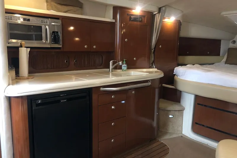 Slide: The Image of Interior of 2008 Sea Ray 340 Sundancer yacht with kitchenette and bed. - 20