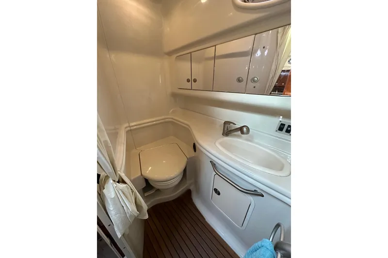 Slide: The Image of 2008 Sea Ray 340 Sundancer bathroom with sink, toilet, and storage cabinets. - 23