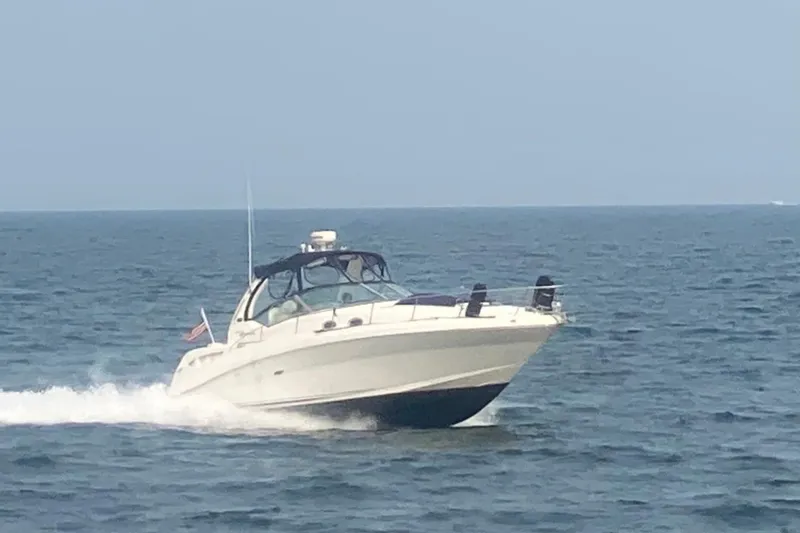 Slide: The Image of 2008 Sea Ray 340 Sundancer docked at a marina with multiple boats. - 4