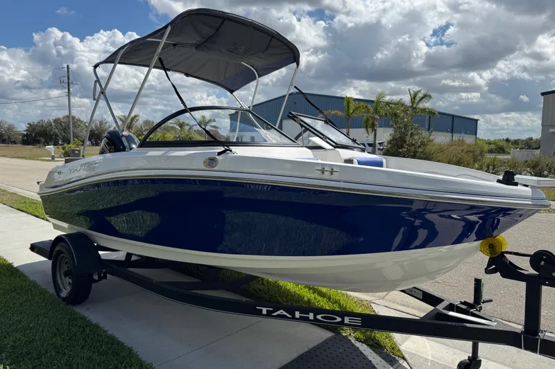 Slide: The Image of 2024 Tahoe 185 S boat on trailer under cloudy sky. - 17