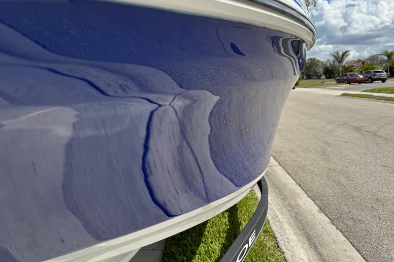 Slide: The Image of 2024 Tahoe 185 S boat with sleek blue hull parked on a sunny street. - 19