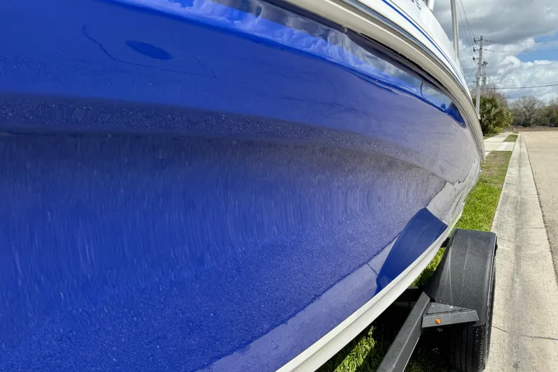 Slide: The Image of 2024 Tahoe 185 S boat with sleek blue hull on trailer. - 20