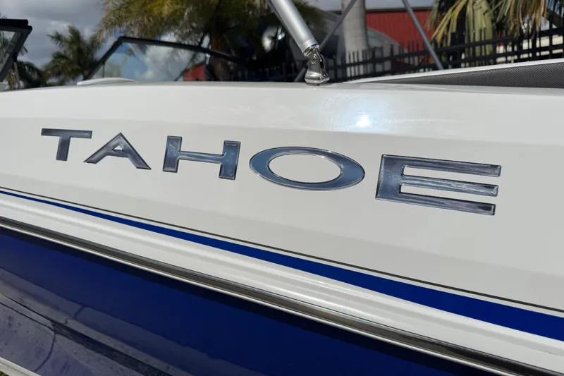Slide: The Image of 2024 Tahoe 185 S boat, close-up of logo on white and blue exterior. - 22