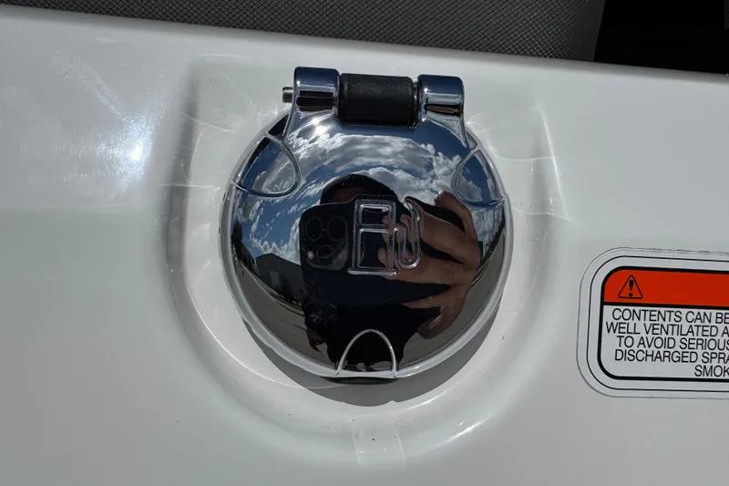 Slide: The Image of Chrome fuel cap on 2024 Tahoe 185 S boat with safety warning label. - 23