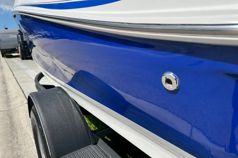 Slide: The Image of 2024 Tahoe 185 S boat, blue and white exterior, on a trailer. - 25
