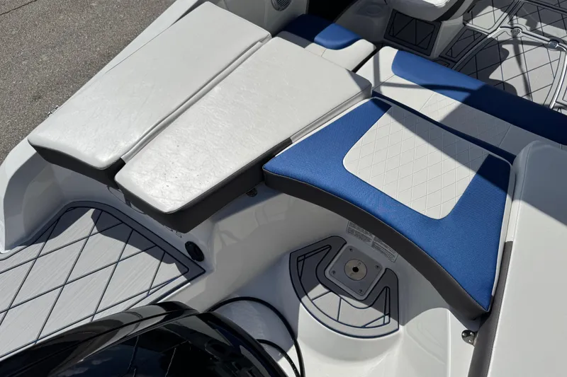 Slide: The Image of 2024 Tahoe 185 S boat interior with white and blue cushioned seating. - 33